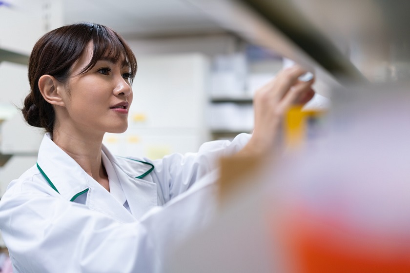 Female pharmacist arranging medicines in pharmacy