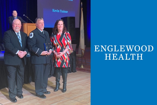 group photo of 2 males and 1 female receiving an award