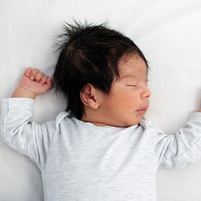 Baby lying down on bed