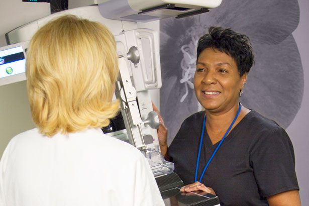 Mammography technician with patient